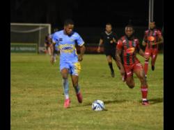 Waterhouse’s Leonardo Jibbison (left) dribbles away from Montego Bay’s Owayne Gordon during their Jamaica Premier League football match at the Montego Bay Sports Complex last night. The game drew 2-2.