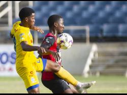  Arnett Gardens’ Joel Cunningham (right) shields the ball from Shawn Daley of Harbour View  during a Jamaica Premier League match on June 20, 2022.