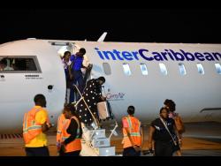 Passengers disembark the InterCaribbean Airways CRJ700 Jet from Bridgetown, Barbados, which arrived at the Norman Manley International Airport in Kingston on Tuesday. InterCaribbean Airways will offer weekly non-stop service between Bridgetown and Kingston.