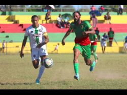 Tivoli’s captain Odean Pennycooke (left) is in a foot race with Humble Lion’s Roshane Sharpe during their Jamaica Premier League encounter at Effortville Community Centre yesterday. Tivoli won 2-0.
