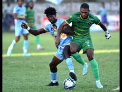 Waterhouse’s Javane Bryan (left) and Vere United’s Alwin Strachan battle of the ball during yesterday’s Jamaica Premier League match at the Anthony Spaulding Sports Complex. Waterhouse won 1-0.
