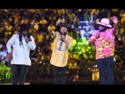 Peetah Morgan (centre) performs with his brothers Mr. Mojo Morgan (left) and Gramps Morgan after the reggae group accepted the Jamaica Reggae Icon Award at the Jamaica 61 Grand Gala held at the National Stadium, St Andrew, last August.