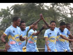 Andre Fletcher (second left) celebrates with teammates after scoring this first of his two goals against Humble Lion yesterday in their Jamaica Premier League football match at Effortville. Waterhouse won 5-1.