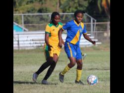Vere United’s captain Mureka Howard (left) tries to get possession from Springers United’s Fredricka Finnikin during their JWPL encounter at the Wembley Centre of Excellence last year. Vere won 3-2.