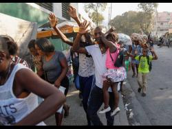 Residents flee their homes during clashes between police and gang members at the Portail neighbourhood in Port-au-Prince, Haiti, last Thursday.