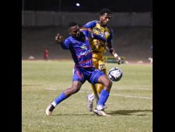 Harbour View’s Rohan Brown (right) pressures Dunbeholden’s Zackiya Wilks during their Jamaica Premier League encounter at Stadium East last night. Dunbeholden won 3-0.