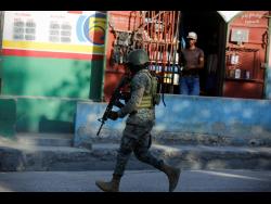 A soldier patrols the outskirts of the international airport in Port-au-Prince, Haiti, on Monday.