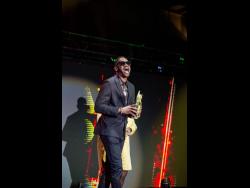 Bounty Killer’ celebrates receiving the Cultural Impact Award at the Reggae Gold Awards last Thursday.