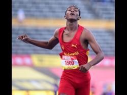 Mario Ross of Wolmer's Boys' School crosses the finish line to heat one of the Class Two boys' 100 metres semi-final at the ISSA/GraceKennedy Boys and Girls' Athletics Championships at the National Stadium today.