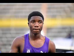 Kingston College's Nyrone Wade is pensive after winning his Class Two boys' 100 metres semi-final at the ISSA/GraceKennedy Boys and Girls' Athletics Championships at the National Stadium today.