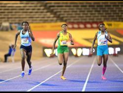 Theianna-Lee Terrelonge (left) of Edwin Allen High wins the Class Two 100 metres final ahead of  Lacovia High’s Sabrina Dockery (right) and Brianna Campbell of St Jago High. Terrelonge won in 11.22 seconds.   