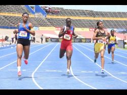 Hydel High School captain, Alliah Baker, leads the duo of Bridgeport's Britney McCormack (centre) and Manchester High's Mickayla Sutherland during a girls' Class 1 200-metre heat at the ISSA/GraceKennedy Boys and Girls' Athletics Championships inside the National Stadium. 