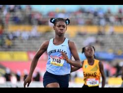 Edwin Allen High's Tashana Godfrey eases after winning the Class Four girls' 70 metres hurdles at the ISSA/GraceKennedy Boys and Girls' Athletics Championships at the National Stadium today. Godfrey clocked 10.56 seconds.