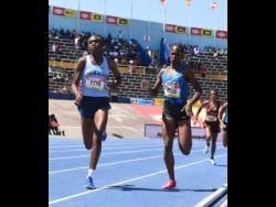 Edwin Allen High's Rickeisha Simms (left) strides to victory in the Class One girls' 800 meters final ahead of Hydel High's Abigail Campbell at the ISSA/GraceKennedy Boys and Girls' Athletics Championships at the National Stadium today. Simms clocked 2:08.56 minutes for the victory.