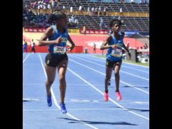 Hydel High's Teixera Johnson (left) looks at the clock after winning the Class Four girls' 200 metres ahead of teammate Tyecia McDonald at the ISSA/GraceKennedy Boys and Girls' Athletics Championships at the National Stadium today. Johnson won in 25.44 seconds.