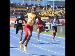 Mario Ross (left) of Wolmer's Boys' School is ecstatic after winning the Class Three boys' 200 metres at the ISSA/GraceKennedy Boys and Girls' Athletics Championships at the National Stadium today. Ross won in 22.21 seconds.