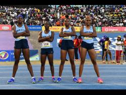 Edwin Allen High's Class Two girls' 4x100 metres relay team members pose after victory at the ISSA/Grace/Kennedy Boys and Girls' Athletics Championships at the National Stadium today.