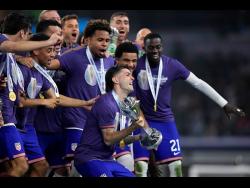 United States of America’s (USA) players celebrate on the podium after their win over Mexico in the Concacaf Nations League final football match on Sunday. USA won 2-0.