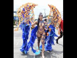 Credit: Ian Allen Alexia Turner ‘chipping’ down the road, in her heels of course, with Yard Mas band on Sunday.