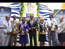 Minister of Labour and Social Security Pearnel Charles Jr (centre), State  Minister in the ministry  Dr Norman Dunn (left) and Permanent Secretary Colette Roberts Risden (right) with PATH top scholars (from second left) Jamay Thomas of Ardenne High School; Dervette Mignott of St Hilda’s Diocesan High School; Evoy Thomas of the Westwood High School; and Kashief Barton of Campion College. The students were among 29 awardees at the PATH Top Achievers Awards at the Spanish Court Hotel in New Kingston.