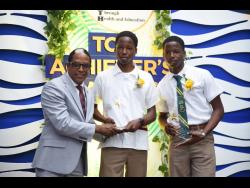 Dr. Norman Dunn (left), minister of state in the Ministry of Labour and Social Security, presents Javier Blake (left) of Dinthill Technical High School and his brother Jevier Blake of St Jago High School with their awards at the PATH Top Achievers Awards held on Thursday at the Spanish Court Hotel in New Kingston.  