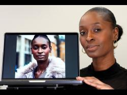 Fashion model Alexsandrah poses with a computer showing an AI generated image of her. (AP Photo/Kirsty Wigglesworth)