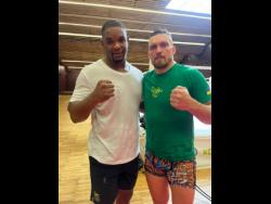 Jamaica’s Ricardo ‘Big 12’ Brown (left) and world heavyweight multi-title holder Oleksandr Usyk of Ukraine after a recent training session.