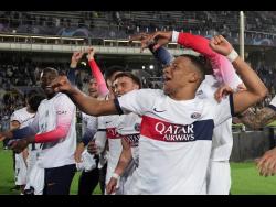 PSG’s Kylian Mbappe celebrates at the end of the Champions League quarterfinal second-leg match between Barcelona and Paris Saint-Germain at the Olimpic Lluis Companys stadium in Barcelona, Spain, yesterday.
