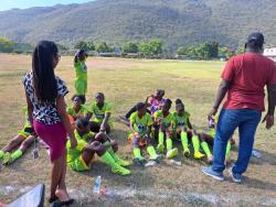 Edith Dalton-James High’s coach Omar Taffe (right), instructs his players at the halftime break of their ISSA/Tip Friendly Schoolgirl Football Zone C quarter-final football match against deCarteret College at Edith Dalton-James recently.