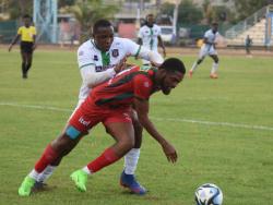 Tivoli Gardens’ Richard Brown (background) tackles Montego Bay United’s Daniel Reid during their Jamaica Premier League football match at the Montego Bay Sports Complex on April 7. Montego Bay won 2-1.