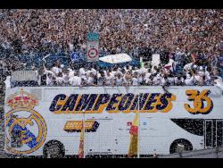Real Madrid players celebrate on an open-topped bus in Cibeles Square yesterday, a week after clinching the La Liga title in Madrid, Spain.