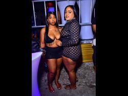Gal pals Deandra (left) and Moya share lens space at YBL all-black anniversary party, held at the Pool Side in Harbour View, east Kingston, recently. 