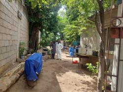 Morgue workers and investigators close to the scene where the bodies of two unidentified men were found yesterday morning in Kingston.