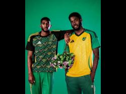 Reggae Boyz Shamar Nicholson (right) and Damion Lowe display the new Adidas home-and-away jerseys. 