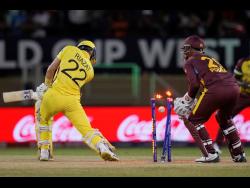 Uganda’s Riazat Ali Shah is bowled by West Indies’ Akeal Hosein for three runs during an ICC Men’s T20 World Cup cricket match at Guyana National Stadium in Providence, Guyana, Saturday, June 8, 2024.