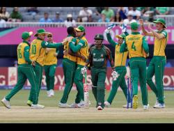 South Africa players celebrate the dismissal of Bangladesh’s Tanzid Hasan (centre)  during the ICC Men’s T20 World Cup cricket match between Bangladesh and South Africa at the Nassau County International Cricket Stadium in Westbury, New York, yesterday.
