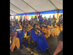 Valedictorian of the latest graduating batch at the Abilities Foundation Anna-Kay Gibson (foreground) is surrounded by fellow graduates.