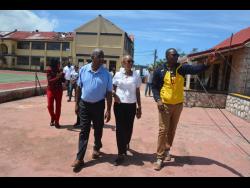 Minister of Education and Youth, Fayval Williams (centre), and Minister of State in the Ministry of Agriculture, Fisheries and Mining and Member of Parliament for St Elizabeth South Eastern, Franklin Witter (left), are led on a tour of Munro College, by Principal, Mark Smith, on Wednesday. At left in the background is Susan Nelson Smith, regional director at the Ministry of Education and Youth – Region 5.