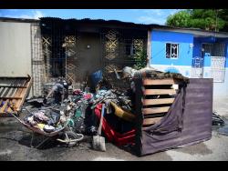Residents lay out household items which were damaged in the fire.