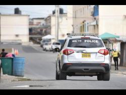 A police service vehicle patrols the west Kingston community of Denham Town. 