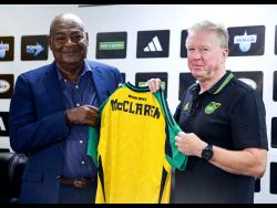 Michael Ricketts, President of the Jamaica Football Federation (JFF) presenting Stephen McClaren, new head coach of the Reggae Boyz with his Reggae Boyz jersey at the JFF press conference in August at the JFF’s office in Kingston. 