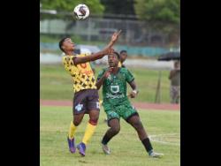 Christopher Hylton (left) of Haile Selassie High School and Jaheim Rankine of Calabar High compete for the ball during their ISSA/WATA Manning Cup football match at Calabar High School on Wednesday. Calabar won 3-0.