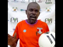 Veteran referee Everton Barrett at the YFL Under-11 Junior Cup eastern regionals at the Constant Spring playing field last Saturday.