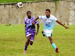 Irwin High School’s Ronaldeno Richards (left) and Maldon High’s Kenroy Thorpe compete for the ball during the ISSA/WATA Zone A football match in the daCosta Cup competition at Irwin High School yesterday. Maldon High won 1-0.