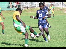 Aldino Nugent (left), of Excelsior High, blocks  Jamaica College’s Jahmarly Bennett during their Manning Cup match at Excelsior High School on Wednesday, October 9, 2024. Jamaica College won 3-1. 