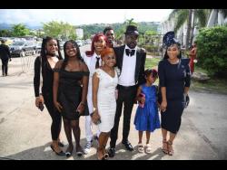 Dancehall artiste Beenie Man and family arriving at the National Honours and Awards Investiture Ceremony held on Monday at the National Indoor Sports Centre.