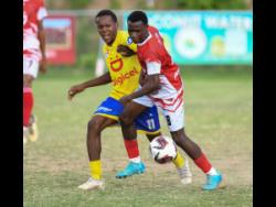 Elijah Whyte of Campion College (right) battles with Andrew Anderson of Jose Marti for the ball during the ISSA Manning Cup football match on October 12 at Campion College.