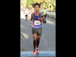 This April 14, 2019 photo shows sprinting towards the finish to win the female section of  the Running Events Jamaica-Everyone’s a Winner 10K at Hope Gardens in Kingston. The multitalented Sharpe created history over the weekend as she became the country’s first female to win the Elite Women’s Road Race at the Elite Caribbean Cycling Championships in Georgetown, Guyana.