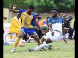 Ronaldo  Robinson (left) of Harbour View is challenged for the ball by Ranaldo Biggs of Racing United during their Jamaica Premier League football match at Stadium East on Sunday.