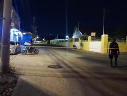 Credit: Simone Morgan-Lindo Police cordon off the area on Waltham Park Road where several persons were shot and killed on Monday.